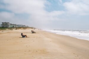 People in beach lounge chairs at Cape Hatteras in North Carolina.