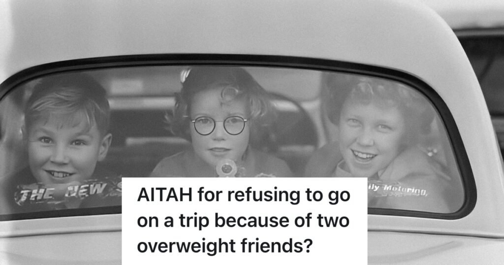 man wrapped in a blanket looking at a thermometer