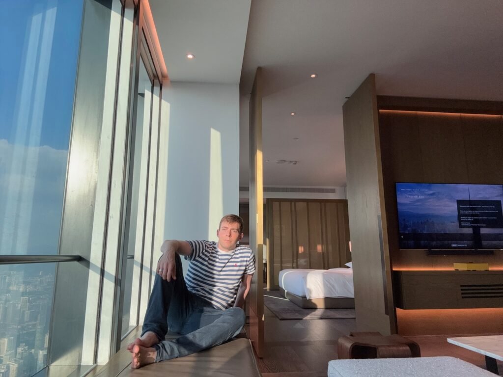 a man sitting on a window sill