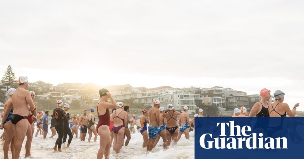 A swim for unity at Bondi beach, the scene of Sydney’s darkest day. But on land tensions fray | Bondi beach terror attack