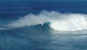 Albee Layer surfing Jaws wave during the first swell of the season