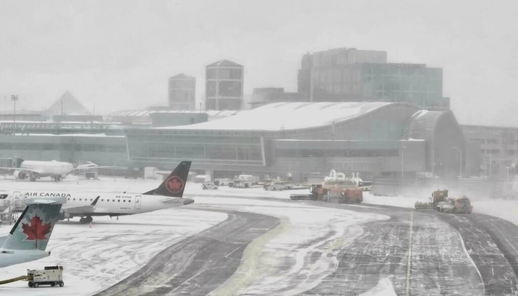 Toronto Pearson airport cancellations spike as snowstorm hits YYZ and YTZ