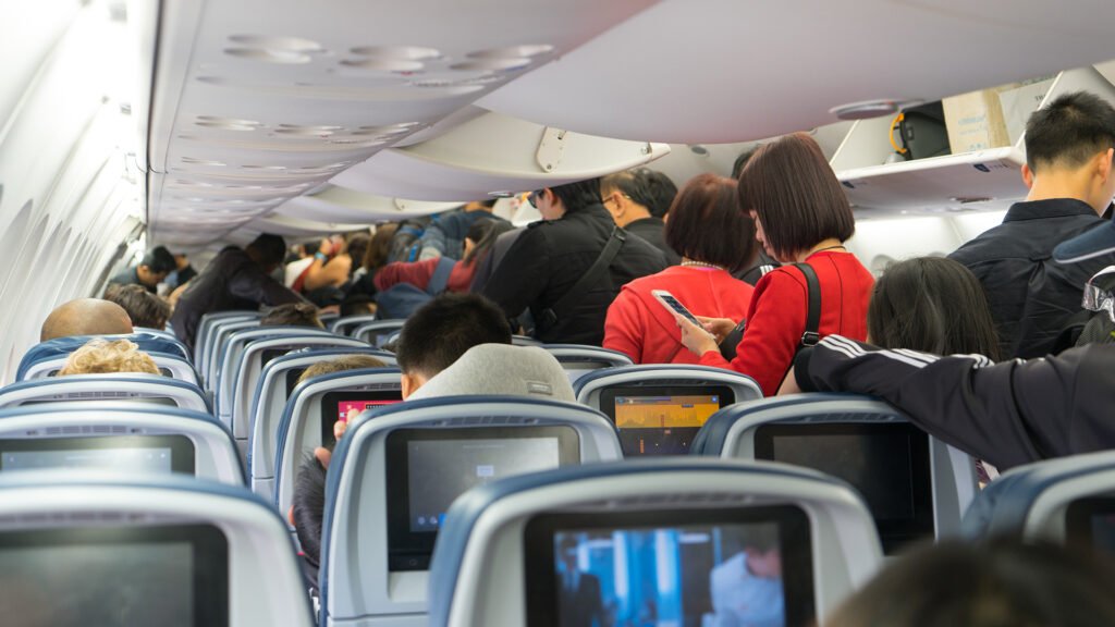 'Unspoken' plane etiquette rule fuels debate over WHEN to stand up after landing