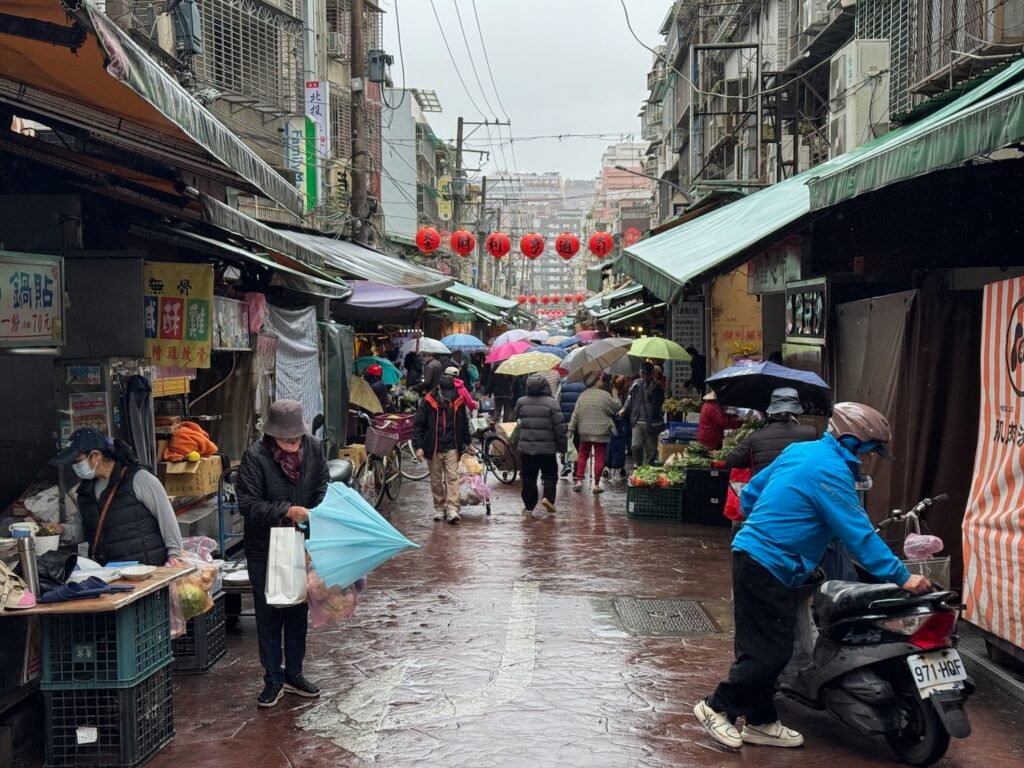 a group of people walking down a street with umbrellas