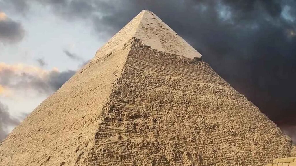Great Pyramid of Giza under dramatic clouds, as a controversial erosion study suggests it may be far older than the Fourth Dynasty