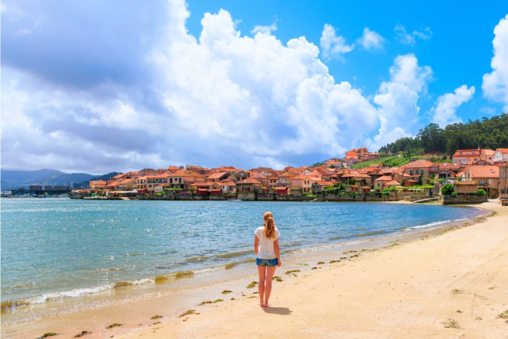 Woman on beach in Combarro, Spain