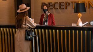 Woman talking to a receptionist in a hotel lobby