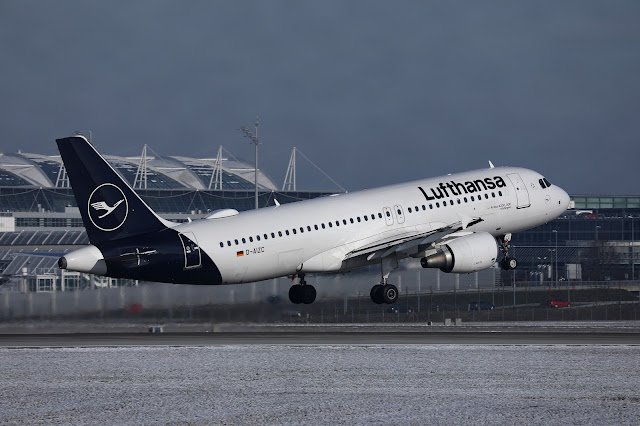 Lufthansa aircraft departing from a snowy runway